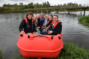 Minister for Housing, Local Government and Heritage, James Browne TD with the Local Authority Waters Programme Community Water Officer David Rafter, local council members and members of the local community attending Edermine Ferry Rowing Club’s official launch of their new workboat purchased with support from the the Local Authority Waters Programme Community Water Development Fund 2025.